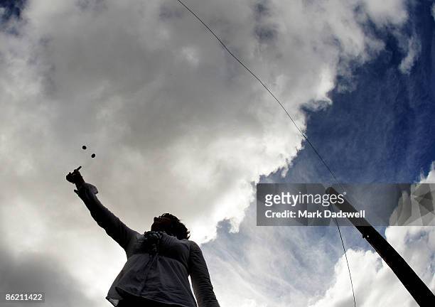 Competitor tosses the coins into the air in a game of Two Up on April 25, 2009 in Avoca, Australia. Today commemorates the 94th anniversary of ANZAC...