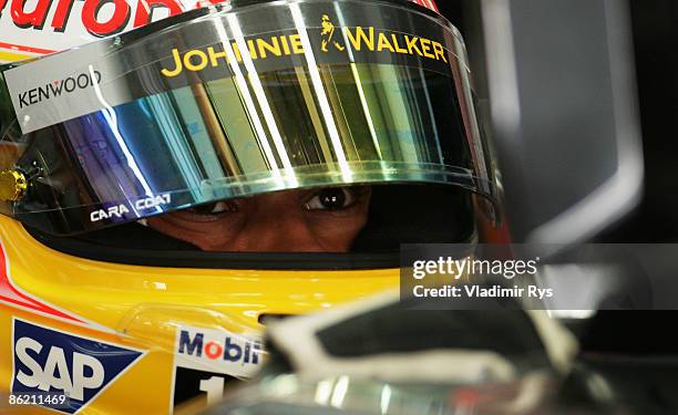 Lewis Hamilton of Great Britain and McLaren Mercedes is seen in his team garage during the final practice session prior to qualifying for the Bahrain...