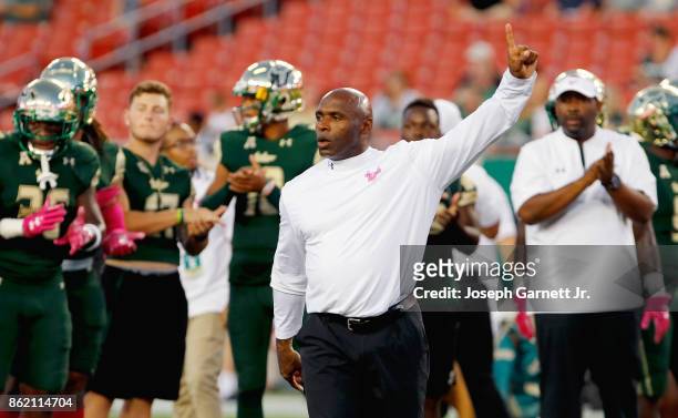Head coach Charlie Strong of the South Florida Bulls gives directions to his team during warmups prior to their game against the Cincinnati Bearcats...