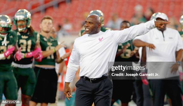 Head coach Charlie Strong of the South Florida Bulls gives directions to his team during warmups prior to their game against the Cincinnati Bearcats...