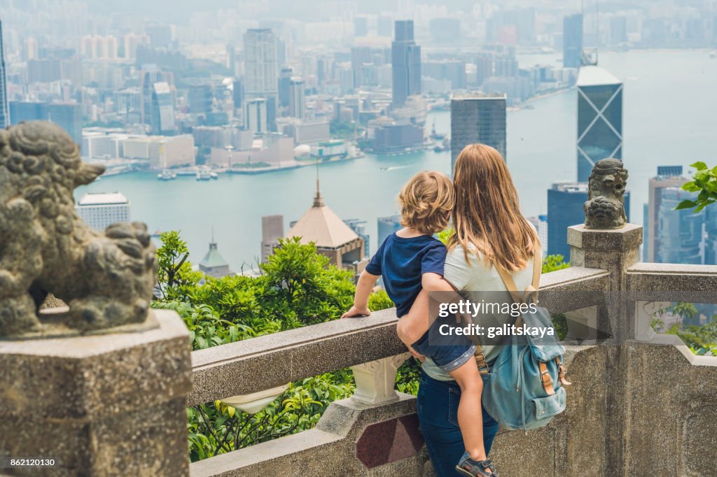 Mom and son travelers at the peak of Victoria against the backdrop of Hong Kong. Traveling with children concept