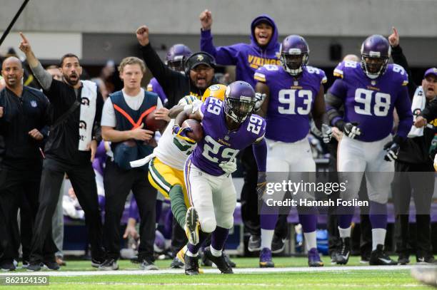 Xavier Rhodes of the Minnesota Vikings carries the ball after an interception as Geronimo Allison of the Green Bay Packers forces him out of bounds...