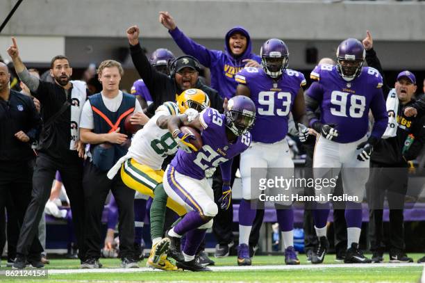 Xavier Rhodes of the Minnesota Vikings carries the ball after an interception as Geronimo Allison of the Green Bay Packers forces him out of bounds...