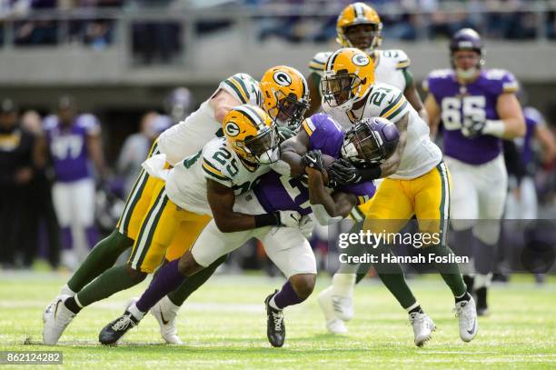 Jerick McKinnon of the Minnesota Vikings is tackled by Kentrell Brice, Jake Ryan and Ha Ha Clinton-Dix of the Green Bay Packers during the game on...