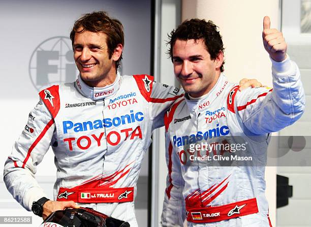 Jarno Trulli of Italy and Toyota celebrates with second placed team mate Timo Glock of Germany and Toyota in parc ferme after taking pole position...