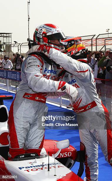 Jarno Trulli of Italy and Toyota celebrates with second placed team mate Timo Glock of Germany and Toyota in parc ferme after taking pole position...