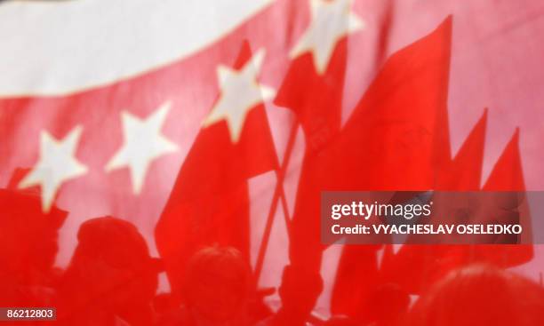 Kyrgyz opposition supporters hold red flags at meeting with Social-Democratic party candidate Almazbek Atambayev during an opposition rally in...