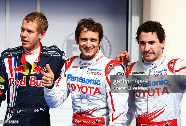 Third placed Sebastian Vettel of Germany and Red Bull Racing, pole sitter Jarno Trulli of Italy and Toyota and second placed Timo Glock of Germany...