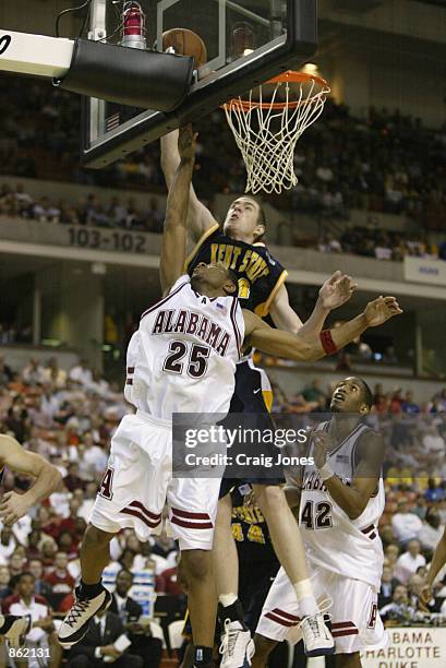 Guard Maurice Williams of the Alabama Crimson Tide goes up to block a shot by center John Edwards of the Kent State Golden Flashes during the game on...