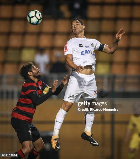 Ricardo Oliveira of Santos battles for the ball with Wallace of Vitoria during the match between Santos and Vitoria as a part of Campeonato...