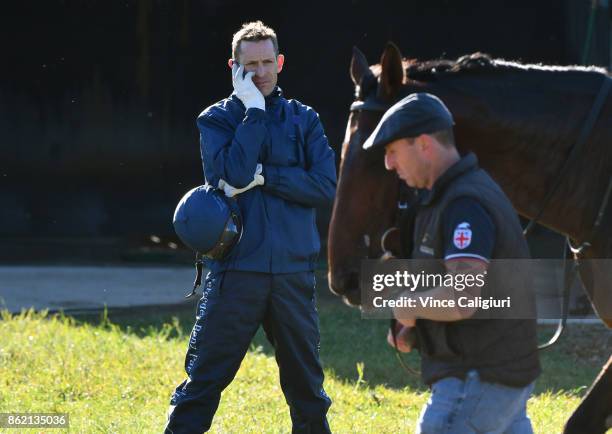 Hugh Bowman is seen talking on the phone after riding Marmelo during track gallop at Werribee Racecourse on October 17, 2017 in Melbourne, Australia.