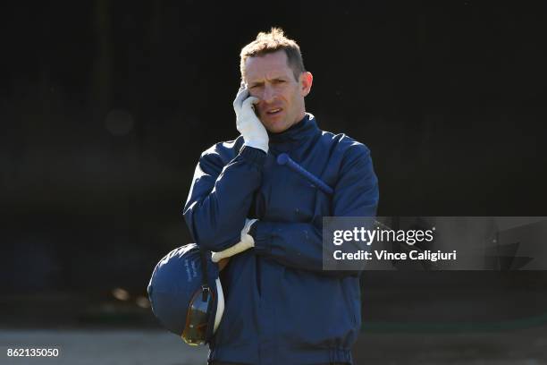 Hugh Bowman is seen talking on the phone after riding Marmelo during track gallop at Werribee Racecourse on October 17, 2017 in Melbourne, Australia.