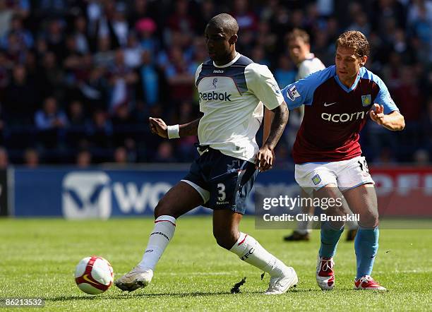 Jlloyd Samuel of Bolton Wanderers clears the ball from Stiliyan Petrov of Aston Villa during the Barclays Premier League match between Bolton...