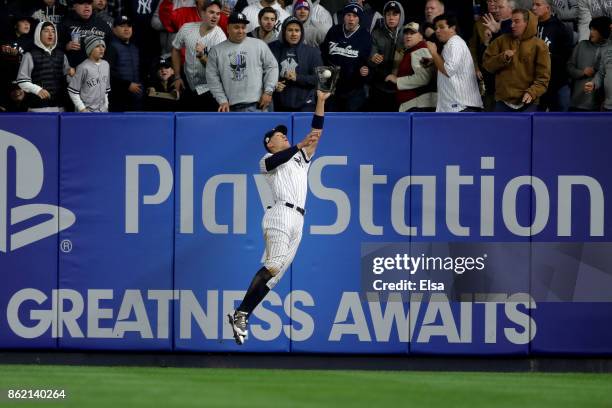 Aaron Judge of the New York Yankees hits the wall while making a catch against the Houston Astros during the fourth inning in Game Three of the...