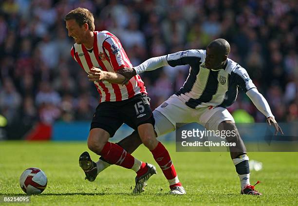 Danny Collins of Sunderland is challenged by Marc-Antoine Fortune of West Bromwich Albion during the Barclays Premier League match between West...