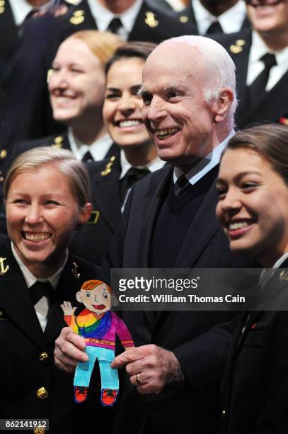 Sen. John McCain poses for photos with a group of Naval cadets after receiving the 2017 Liberty Medal from former Vice President Joe Biden at the...