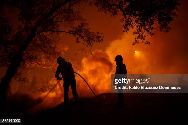 Firefighters battle a forest wildfire next to Vilarinho village, near Lousa on October 16, 2017 in Coimbra region, Portugal. At least 36 people have...