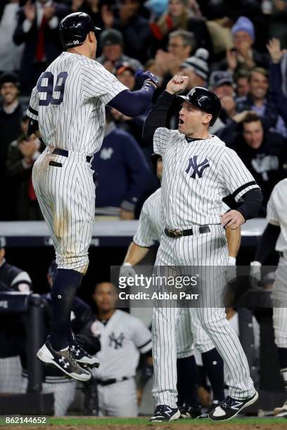 Aaron Judge of the New York Yankees celebrates hitting a 3-run home run against the Houston Astros during the fourth inning with teammate Chase...