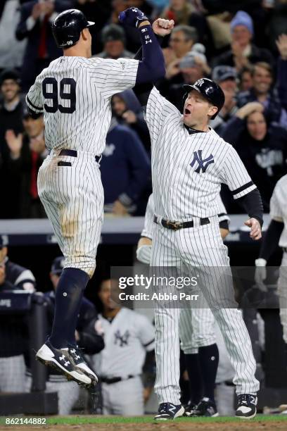 Aaron Judge of the New York Yankees celebrates hitting a 3-run home run against the Houston Astros during the fourth inning with teammate Chase...