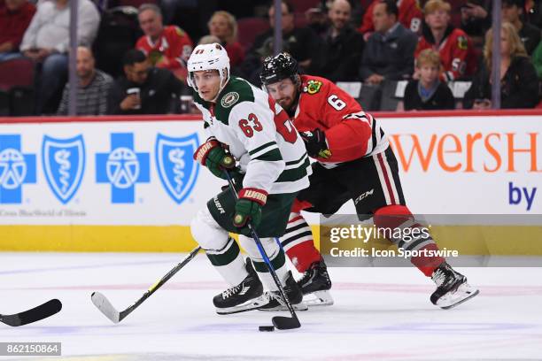 Minnesota Wild left wing Tyler Ennis controls the puck against Chicago Blackhawks defenseman Michal Kempny during a game between the Chicago...