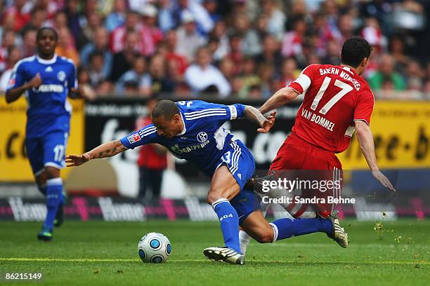 Mark van Bommel of Bayern is tackled by Jermaine Jones of Schalke during the Bundesliga match between FC Bayern Muenchen and FC Schalke 04 at the...