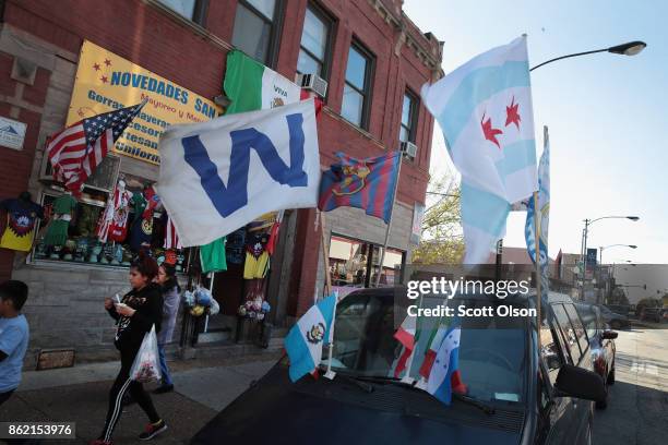 Vendor sells flags along a commercial strip in the predominately Mexican Little Village neighborhood on October 16, 2017 in Chicago, Illinois. The...
