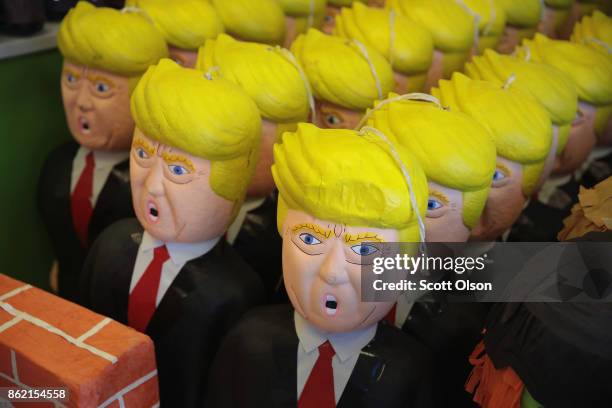 President Donald Trump pinatas are offered for sale in a party store along a commercial strip in the predominately Mexican Little Village...