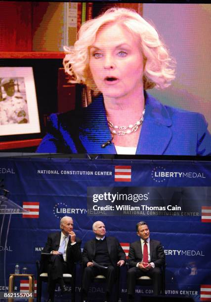 Former Vice President Joe Biden, Sen. John McCain and National Constitution Center President and CEO Jeffrey Rosen watch a video about McCain before...