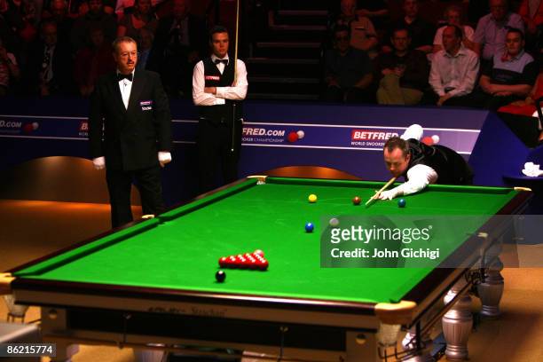John Higgins of England breaks in his match against Jamie Cope of England during the 2nd round of the Betfred World Snooker Championships at the...