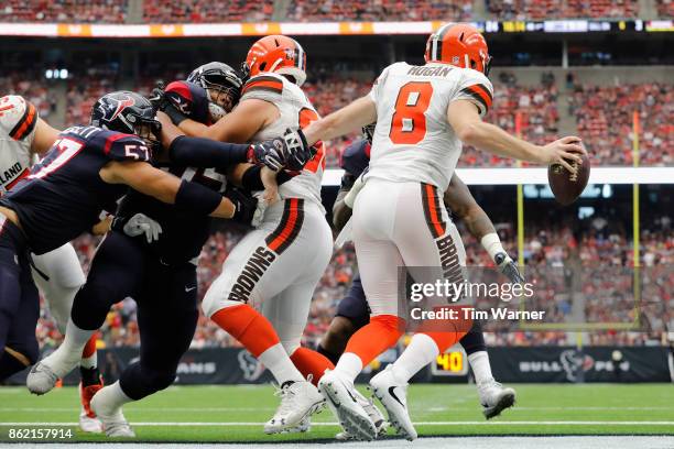 Christian Covington of the Houston Texans grabs Kevin Hogan of the Cleveland Browns in the end zone during the third quarter at NRG Stadium on...