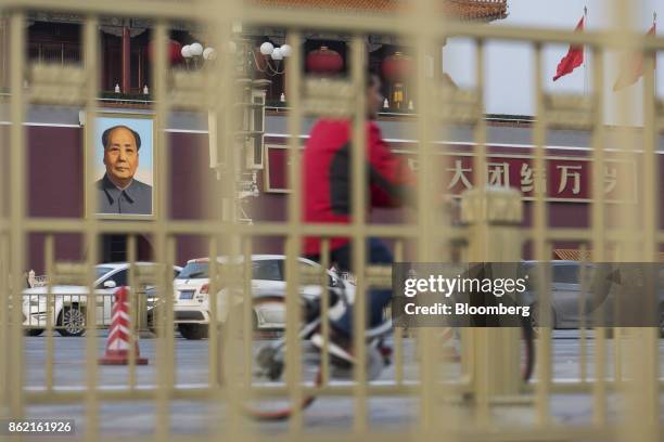 Portrait of former Chinese leader Mao Zedong is seen through a fence at Tiananmen Square in Beijing, China on Monday, Oct 16, 2017. President Xi...