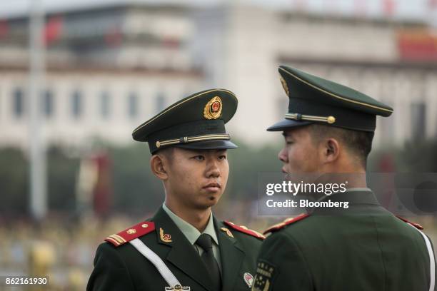 Members of the Chinese People's Liberation Army stand guard prior to a flag lowering ceremony at Tiananmen Square in Beijing, China on Monday, Oct...