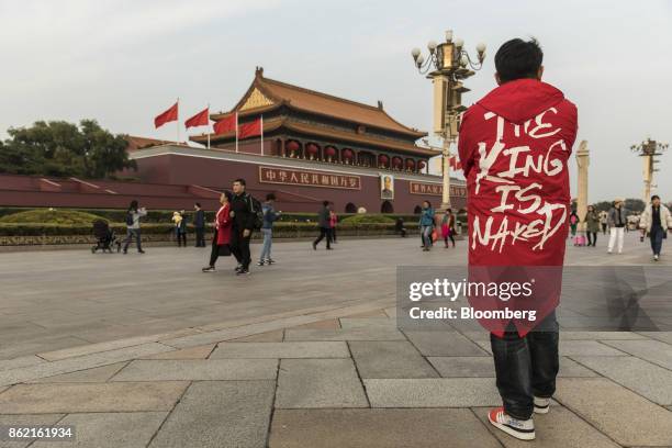 Tourists and pedestrians walk past a portrait of former Chinese leader Mao Zedong at Tiananmen Square in Beijing, China on Monday, Oct 16, 2017....