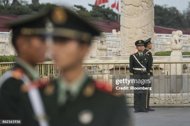 Members of the Chinese People's Liberation Army stand guard prior to a flag lowering ceremony at Tiananmen Square in Beijing, China on Monday, Oct...