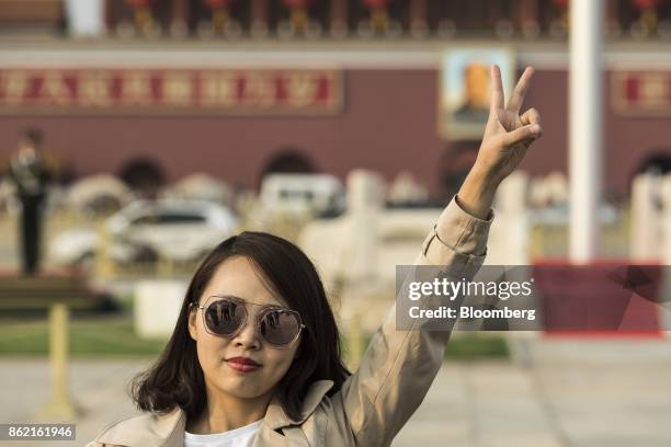 Visitor poses for a photograph at Tiananmen Square in Beijing, China on Monday, Oct 16, 2017. President Xi Jinping is expected to emerge from the...