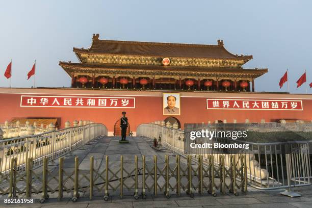 Member of the Chinese People's Liberation Army stands guard in front of a portrait of former Chinese leader Mao Zedong at Tiananmen Square in...