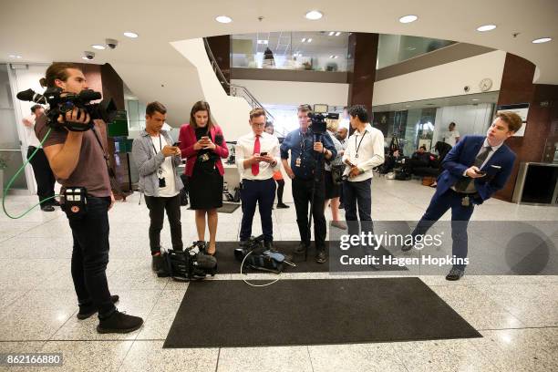 Media wait for leader Winston Peters to make an appearance during a NZ First caucus and board meeting at Parliament on October 17, 2017 in...