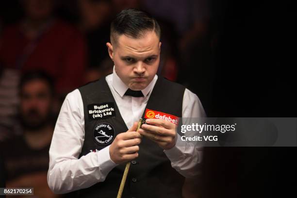 Elliot Slessor of England reacts during his first round match against John Higgins of Scotland on day one of 2017 Dafabet English Open at Barnsley...