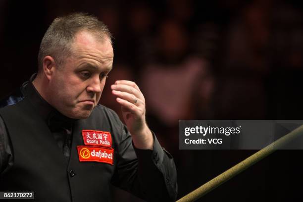 John Higgins of Scotland reacts during his first round match against Elliot Slessor of England on day one of 2017 Dafabet English Open at Barnsley...