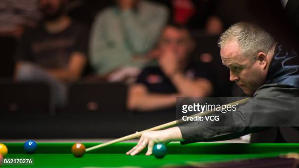 John Higgins of Scotland plays a shot during his first round match against Elliot Slessor of England on day one of 2017 Dafabet English Open at...