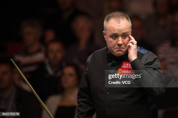 John Higgins of Scotland reacts during his first round match against Elliot Slessor of England on day one of 2017 Dafabet English Open at Barnsley...