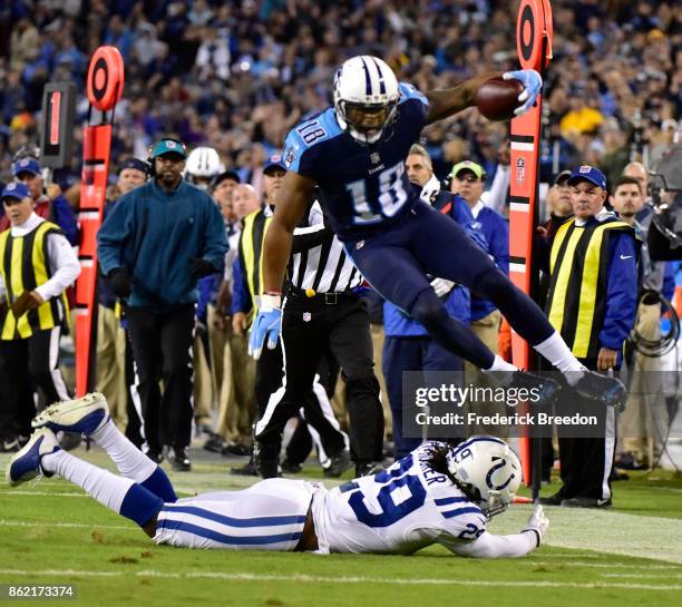 Rishard Matthews of the Tennessee Titans jumps over Malik Hooker of the Indianapolis Colts during the second half of a 36-22 Titan victory at Nissan...