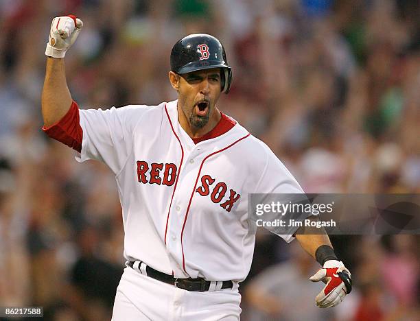 Mike Lowell of the Boston Red Sox celebrates as he rounds the bases after hitting a home run against the New York Yankees at Fenway Park, April 25 in...