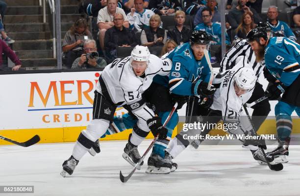 Christian Folin and Nick Shore of the Los Angeles Kings look with Joe Pavelski of the San Jose Sharks at SAP Center on October 7, 2017 in San Jose,...