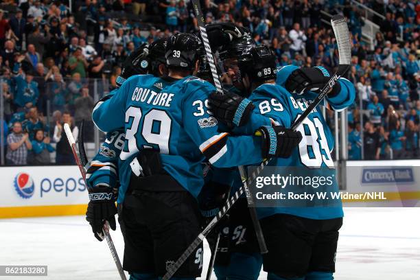 Logan Couture and Mikkel Boedker of the San Jose Sharks celebrate Boedker's goal with teammates during a NHL game against the Los Angeles Kings at...