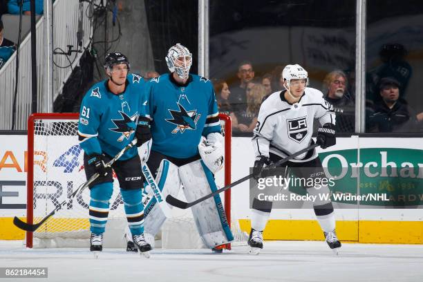 Justin Braun and Martin Jones of the San Jose Sharks defend against Dustin Brown of the Los Angeles Kings at SAP Center on October 7, 2017 in San...