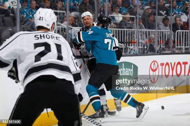 Dylan DeMelo of the San Jose Sharks hits a Los Angeles Kings player at SAP Center on October 7, 2017 in San Jose, California.
