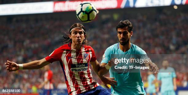 Filipe Luis of Atletico Madrid and Andre Gomes battle for the ball during the La Liga match between Club Atletico Madrid and FC Barcelona at Estadio...