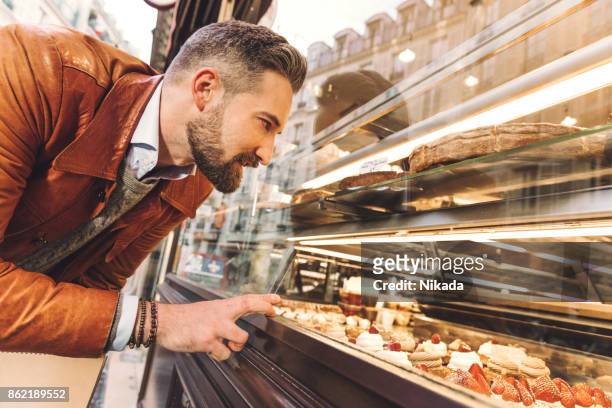 bakery window shopping in paris - bakery shop stock pictures, royalty-free photos & images