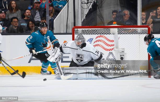 Jonathan Quick of the Los Angeles Kings goes to block the puck during a NHL game against the San Jose Sharks at SAP Center on October 7, 2017 in San...